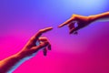 Two human hands trying to touch each other  on gradient blue-pink background in neon light. Concept of human Royalty Free Stock Photo