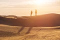 Two human silhouettes in the sand desert