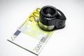 Two hundred euro banknote and loupe or Magnifier for authentication on a white isolated background. Concept - checking money for Royalty Free Stock Photo