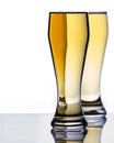 Two Ice Cold Beer Glasses on Reflective Surface