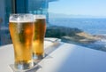 Two ice cold beers on a table outdoors at sun down Royalty Free Stock Photo