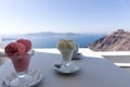 Two ice cream sundaes on the table with view of the Mediterranean Sea