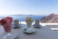 Two ice cream sundaes on the table with view of the Mediterranean Sea