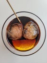 Two ice cubes and an orange slice in a drink symbolizing a smiling face. Happiness, carpe diem, enjoy the good times Royalty Free Stock Photo