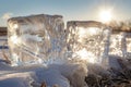 Two ice cubes sitting still on top of a winter wonderland covered in fresh snow, Ice sculptures sparkling in the midday sun, AI Royalty Free Stock Photo