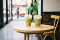 two iced matcha teas on a caf table with a reserved sign, no people