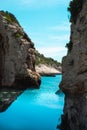 Two iconic rocks of the Stiniva bay in Croatia. Beautiful blue summer day, reflection of the rocks on the crystal clear blue sea