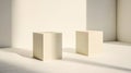 Two identical beige rectangular blocks stand side by side against a white wall. Royalty Free Stock Photo