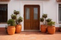 two identical terracotta pots beside a spanish villas door Royalty Free Stock Photo