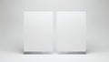 Two identical white rectangular objects standing side by side on a plain surface Royalty Free Stock Photo