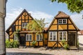 Two idyllic half-timbered houses with roses along the walls