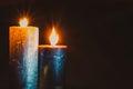 Burial concept with two burning candles against black background Royalty Free Stock Photo