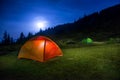 Two Illuminated orange and green camping tents