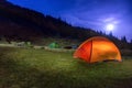 Two Illuminated orange and green camping tents