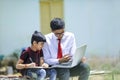 Two indian brother using laptop , Online education concept