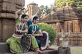 Two Indian classical odissi dancers striking a pose in front of Mukteshvara Temple,Bhubaneswar, Odisha, India