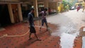 Two Indian Cleaner clean a road.