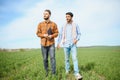 Two indian farmer standing at agriculture field. The concept of agriculture Royalty Free Stock Photo