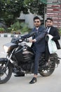 Two indian friends sitting on bike