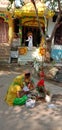 Two indian ladies worship a god on holyday.