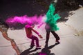 Two indian men in colorful powder clouds for Holi, Jaipur, Rajasthan, India Royalty Free Stock Photo