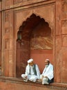 Two indian men sitting at Jama Masjid, Delhi Royalty Free Stock Photo