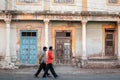 Two Indian men walking past an old building Royalty Free Stock Photo