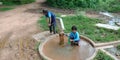 Two indian village school filling water bottle at hand water pump Royalty Free Stock Photo