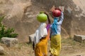 Two Indian women carry water on their heads in Royalty Free Stock Photo