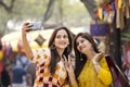 Two women taking selfie at Surajkund Mela