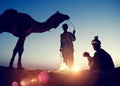 Two Indigenous Indian Men Resting Camel Concept