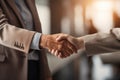 Two individuals in a close-up shot, engaging in a handshake gesture