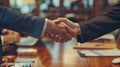 Two men are gesturing over a polished hardwood table Royalty Free Stock Photo