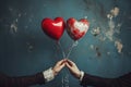 Two individuals joyfully hold red and white heart-shaped balloons together, Two hands entwined with love hearts and balloon Royalty Free Stock Photo