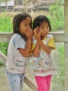 Two Indonesian Girls Whispering