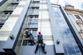 Team of industrial climbers at work, they are washing building f Royalty Free Stock Photo