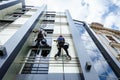 Team of industrial climbers at work, they are washing building f Royalty Free Stock Photo