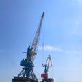 Two industrial cranes on a blue sky Royalty Free Stock Photo