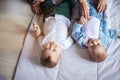 Two infant boys standing near vintage sofa happy smiling learn to walk Royalty Free Stock Photo