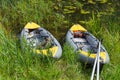 Two inflatable boats moored to the river bank Royalty Free Stock Photo