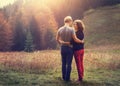 Two inlove young people on the sunset forest glade Royalty Free Stock Photo