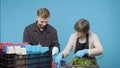 Flower arrangement workshop with instructors on blue background