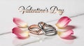 Two Interlocking Heart Rings Surrounded by Pink Rose Petals on White Background Royalty Free Stock Photo