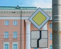 two international road signs indicating the main road