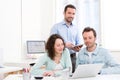 Two interns working together assisted by their course supervisor Royalty Free Stock Photo