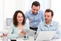 Two interns working together assisted by their course supervisor Royalty Free Stock Photo