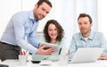 Two interns working together assisted by their course supervisor Royalty Free Stock Photo