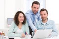 Two interns working together assisted by their course supervisor Royalty Free Stock Photo