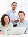 Two interns working together assisted by their course supervisor Royalty Free Stock Photo