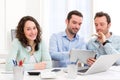 Two interns working together assisted by their course supervisor Royalty Free Stock Photo